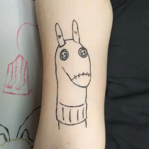 arm adorned with a fun line-art tattoo